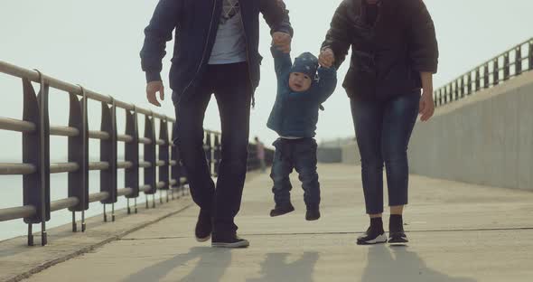 Korean Kid Walks with His Mom and Dad and He Laughs