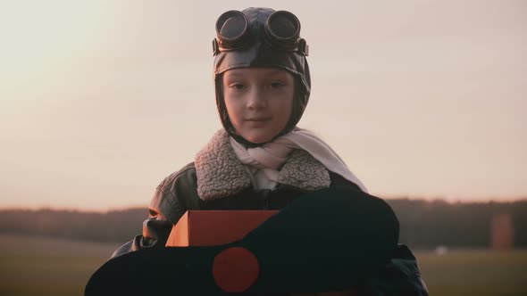Beautiful Portrait Shot of Little Girl in Fun Retro Plane Pilot Costume Looking at Camera with