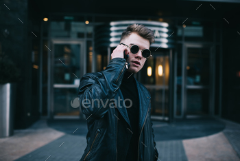 Man in black clothing talking on phone