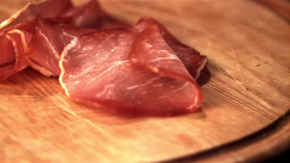 Super Slow Motion on the Cutting Board Fall Chunks of Jerky Meat