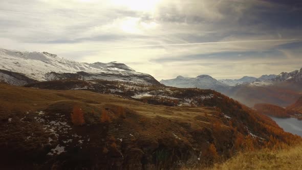 Side POV Walking on Fall Discovering Woods Valley Lake and Snowy Mounts