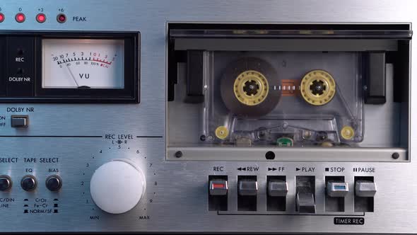 Transparent Audio Cassette Tape Recording Playing in Vintage Silver Deck Player