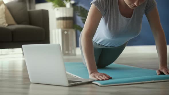 Static video of woman doing push ups at home