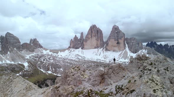 Aerial Man Hiker In Front of Tre Cime di Lavaredo Mountain in Dolomites Italy