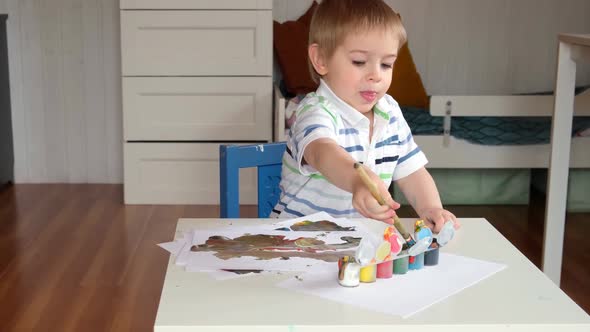 Little Boy Draws Picture On Paper