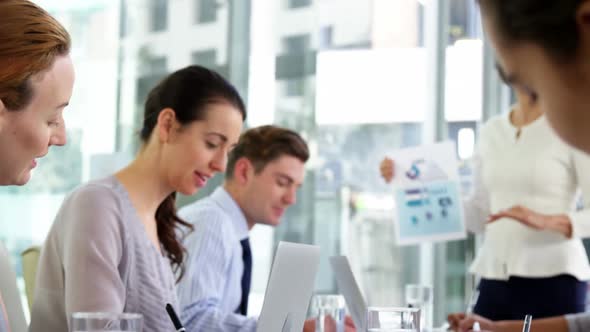 Businesswoman leading meeting in conference room