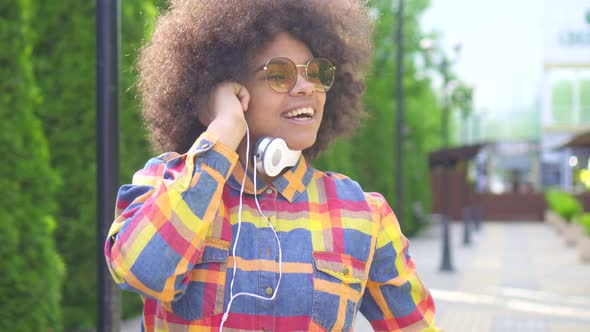 Dancing Fun African American Woman with an Afro Hairstyle on the Street Close Up