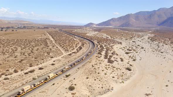 Aerial view of large scale military transport operation. US Armying vehicles by train across America