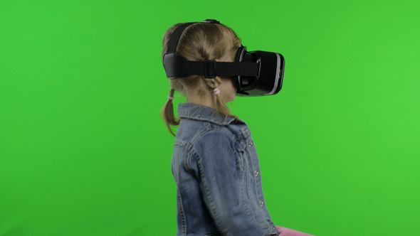 Child Girl Using VR App Helmet To Play Simulation Game, Drawing. Watching Virtual Reality 3d Video