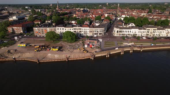 Aerial descending movement showing quay under construction along river IJssel with work in progress