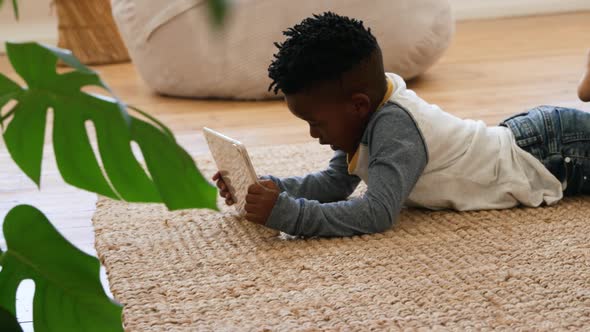 Boy using tablet computer at home