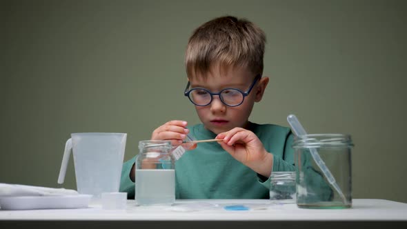 Little Scientist Doing Experiments. Education Concept. Child Doing Chemical Research in Laboratory