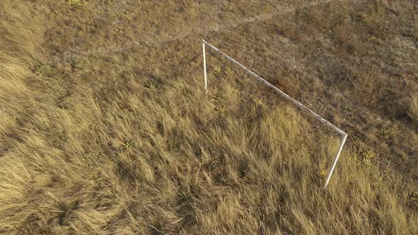 Soccer goal on abandoned terrain 4K aerial video