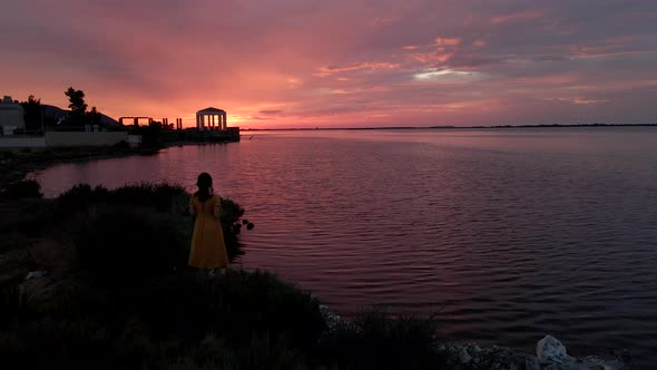 Woman Looking at Sunset Above Lefkada Town