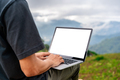 Young man freelancer working online using laptop and enjoying the beautiful nature landscape - PhotoDune Item for Sale