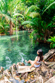 Young woman tourist relaxing and enjoying at klong nam sai in Krabi, Thailand - PhotoDune Item for Sale