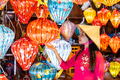 Young female tourist in Vietnamese traditional dress looking at Paper ornamental lanterns in Hoi An - PhotoDune Item for Sale