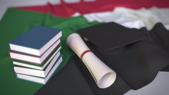 Graduation Cap and Diploma on the Flag of Sudan