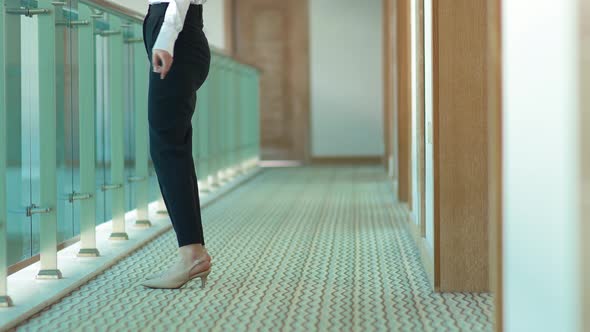 Feet of businesswoman walking in the corridor.