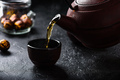 Pouring ready red tea into tea bowl - PhotoDune Item for Sale