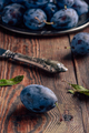 Ripe plums with leaves and knife - PhotoDune Item for Sale