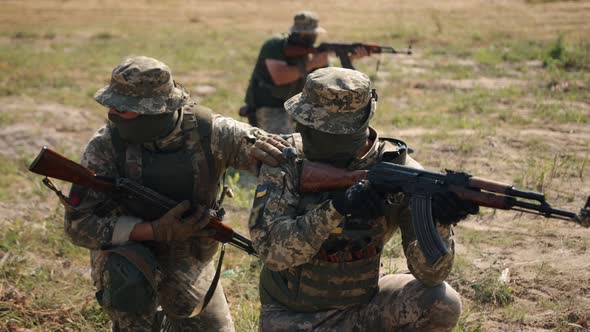 Military Special Forces Unit of Soldiers with Weapons and Ammunition are on Battlefield Attacking