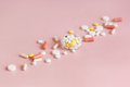 Medical pills and capsules in a bowl on light pink close up. Assorted pharmaceutical products - PhotoDune Item for Sale