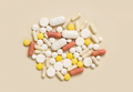 Mix of medical capsules and pills on light beige top view. Medicinal treatment - PhotoDune Item for Sale