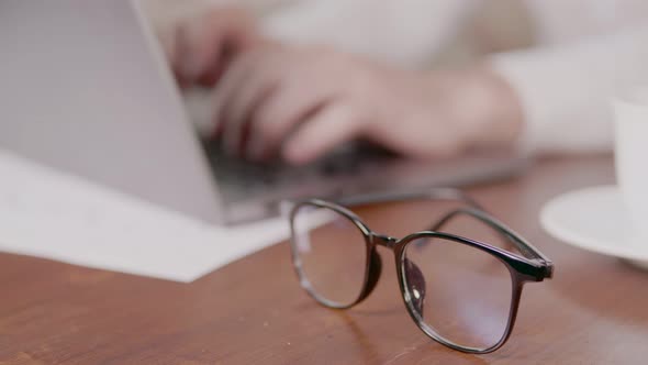 Businessman Despairing While Sitting at Laptop