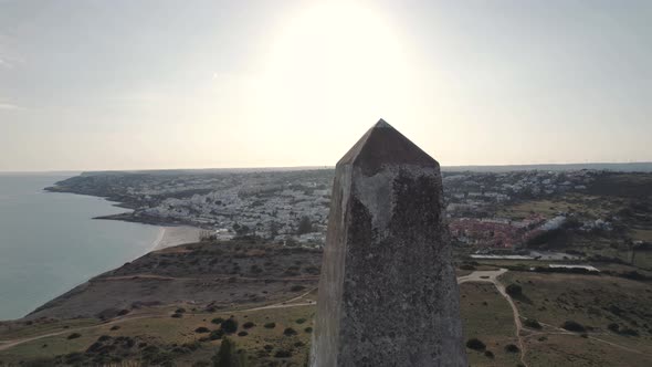 Marco Geodesico da Atalaia against Praia da Luz beach and cityscape . Aerial view