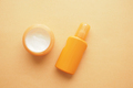 top view of sunscreen cream on a orange color background  - PhotoDune Item for Sale
