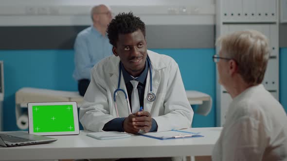 Multi Ethnic Doctor and Old Patient Doing Checkup with Green Screen