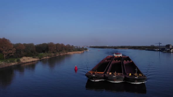 Empty Vessels Cruising Through River Oude Maas Holland Netherlands - wide shot