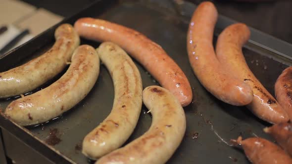 Sausages on the grill. Movement slow motion shot.
