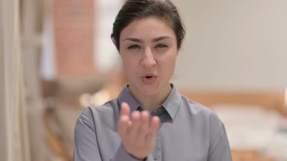 Portrait of Young Indian Woman Giving Flying Kiss