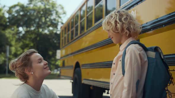 Smiling Happy Mom Chatting with Son at Bus