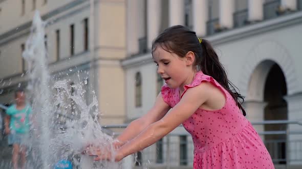 Girl Splashing in the Fountain