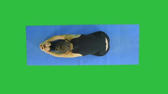 Shoot of Young Caucasian Gymnast When She Warming Up on a Green Screen, Chroma Key