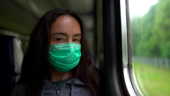 Middle Aged Woman with Medical Mask on Face in Suburban Train, Travelling To Outskirts