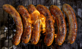Delicious juicy sausages, cooked on the grill with a fire. - PhotoDune Item for Sale