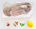 Raw octopus with ingredients for cooking preparation. Top view. - PhotoDune Item for Sale