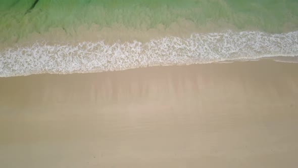 Ascending Over Sand Beach Waves and Green Sea