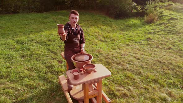Aerial Drone Fly Over Man Potter Work with Clay Ware