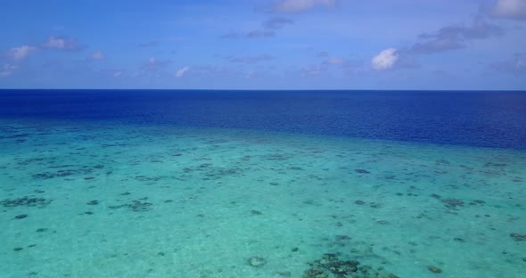 Daytime drone abstract view of a white paradise beach and aqua turquoise water background in 4K