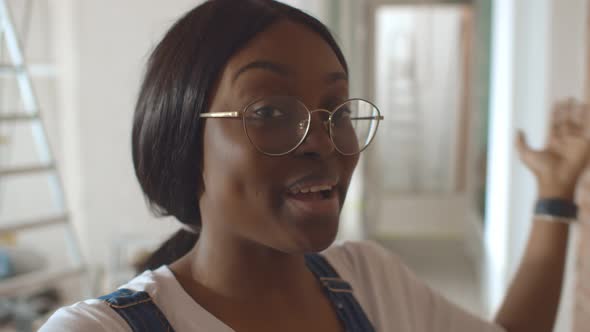 Pov Shot of Young African Woman Having Video Call While Doing Home Renovation