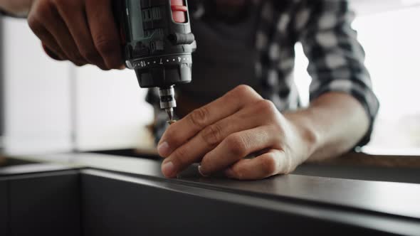 Handheld video of carpenter using a cordless drill. Shot with RED helium camera in 8K