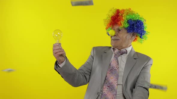 Senior Clown Businessman Entrepreneur Show Light Bulb. Came Up with Great Idea