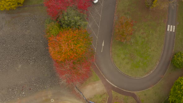 Static aerial view looking at empty car park during coronavirus health restriction lockdowns.