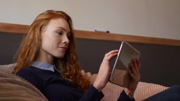 Caucasian woman using computer tablet in creative office