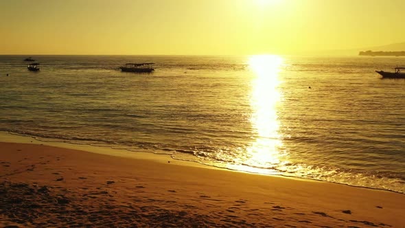 Aerial above travel of exotic resort beach vacation by aqua blue ocean and white sandy background of